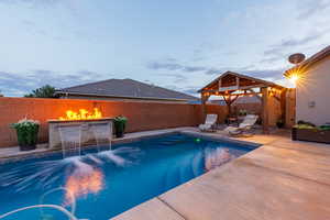 View of swimming pool featuring a covered lounge area