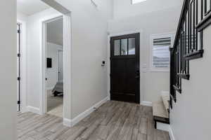 Foyer featuring stairway and wood tiled floors