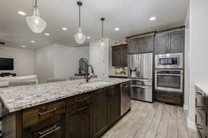 New LG refrigerator with original stainless steel Whirlpool refrigerator in the garage.