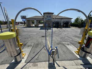 View of asphalt road featuring street lighting