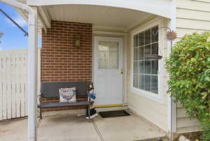 Doorway to property featuring brick siding