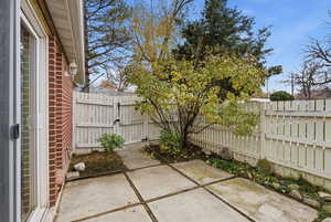 Fenced backyard with a patio area