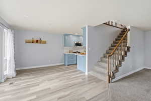 Stairs featuring recessed lighting and wood finished floors