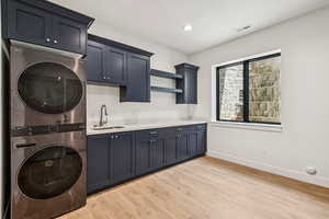 Mudroom/Laundry #1, featuring stacked washer/dryer, laundry sink, cabinets and storage lockers