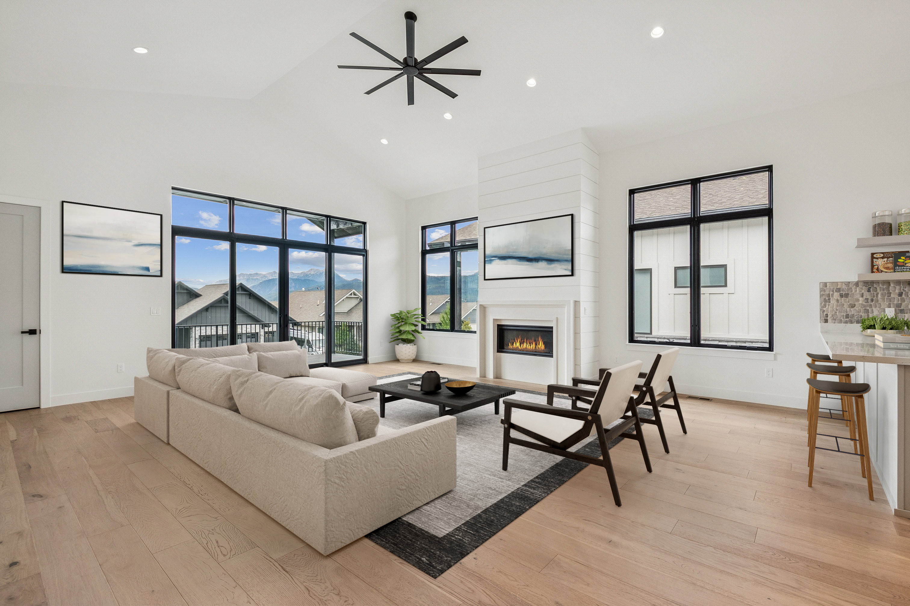 Upper level great room with large windows and sliding door to outside deck. (virtual staging)