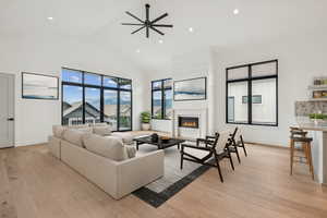 Upper level great room with large windows and sliding door to outside deck. (virtual staging)