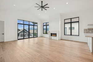 Upper level great room with large windows and sliding door to outside deck.