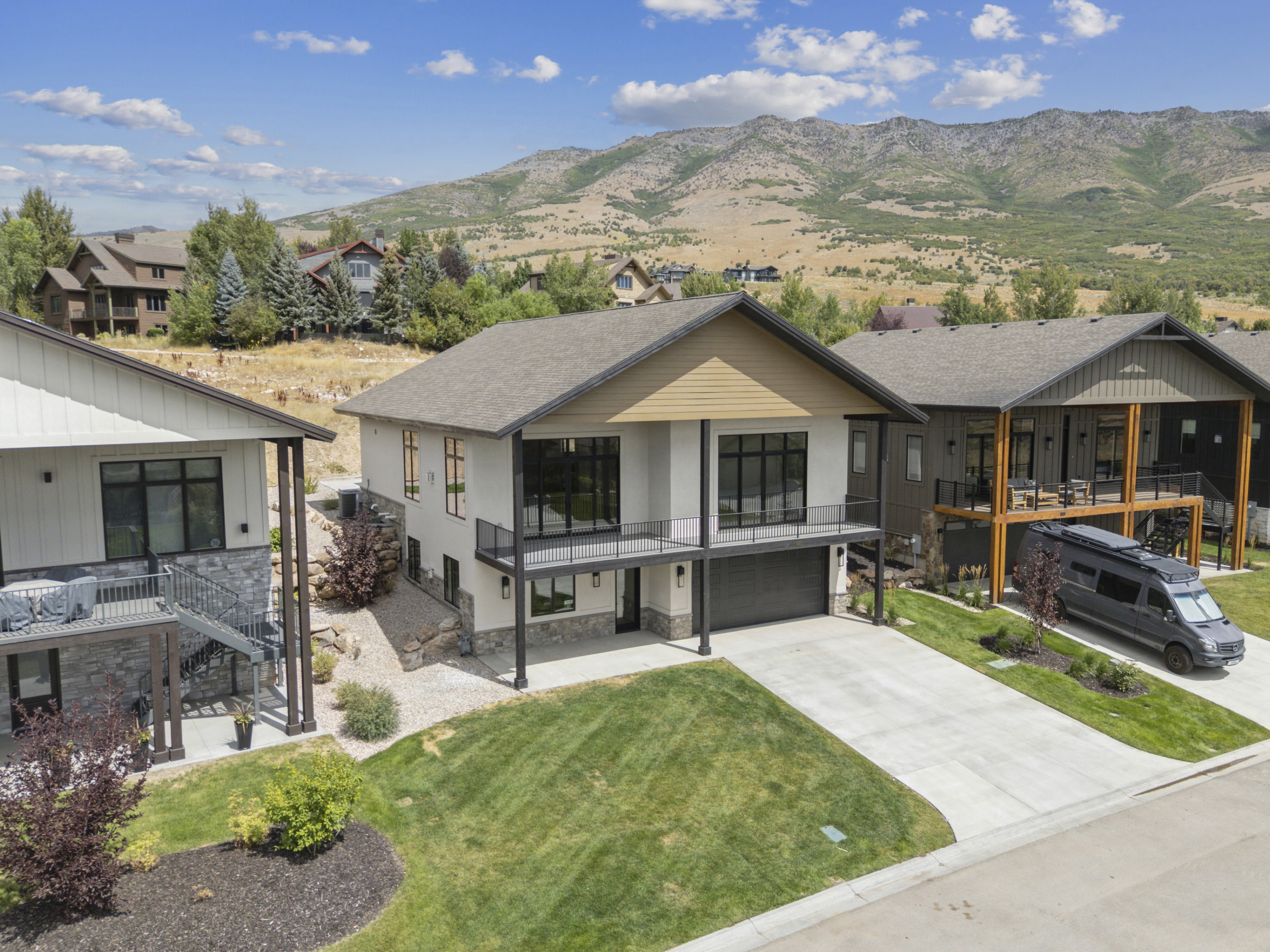 View of front of home featuring upper deck from family room/kitchen area and owner's suite