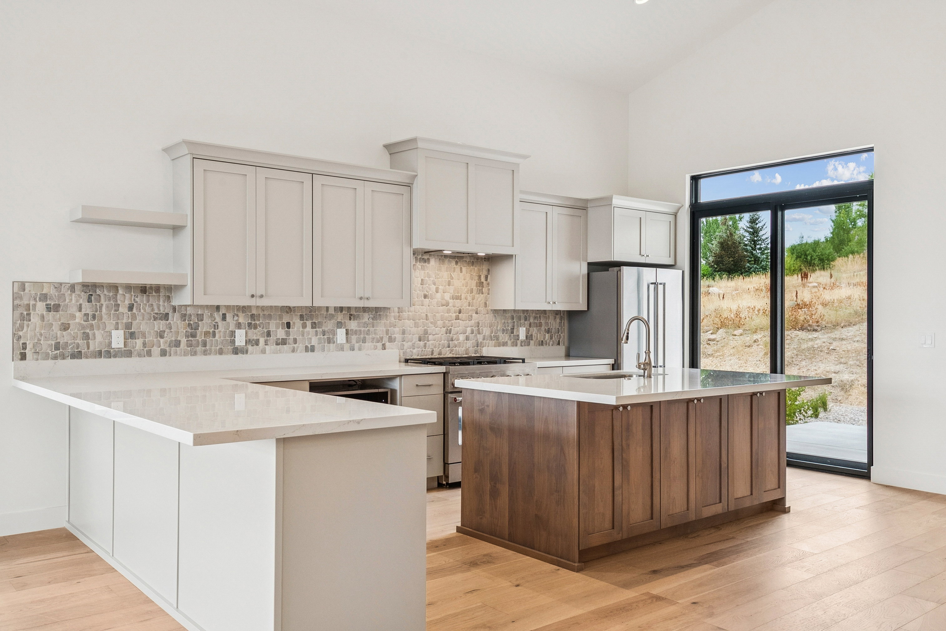 Well equiped Kitchenaid appliance package, including stainless steel fridge with plenty of seating at counter and island to see what's cooking.