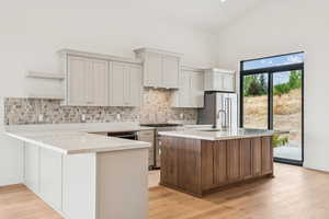 Well equiped Kitchenaid appliance package, including stainless steel fridge with plenty of seating at counter and island to see what's cooking.