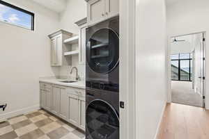 Laundry #2 with stacked washer and dryer, laundry sink, storage and opposite side pantry area.