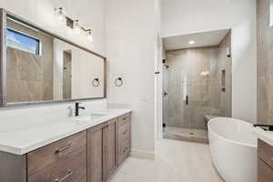 Primary Bathroom (#6) featuring vanity, a soaking tub, Euro shower, and light patterned tile floors