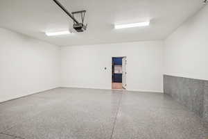 Painted garage with epoxy floors and EV Charger. Direct access to mud room/laundy area and main level area