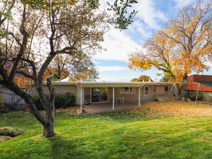 Back of property featuring brick siding and a patio