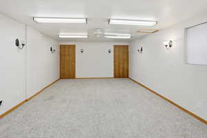 Empty room featuring light carpet and ceiling fan