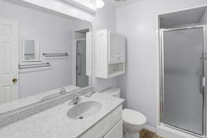 Bathroom with a shower stall and vanity