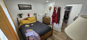 Bedroom with wood finished floors and recessed lighting