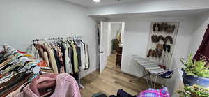 Walk in closet featuring wood finished floors