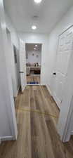 Corridor with light wood finished floors and baseboards