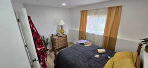 Bedroom with wood finished floors and recessed lighting