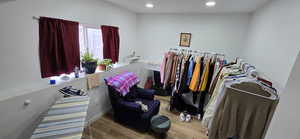 Walk in closet with wood finished floors