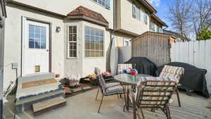 View of patio / terrace with outdoor dining space, entry steps, grilling area, and a storage unit