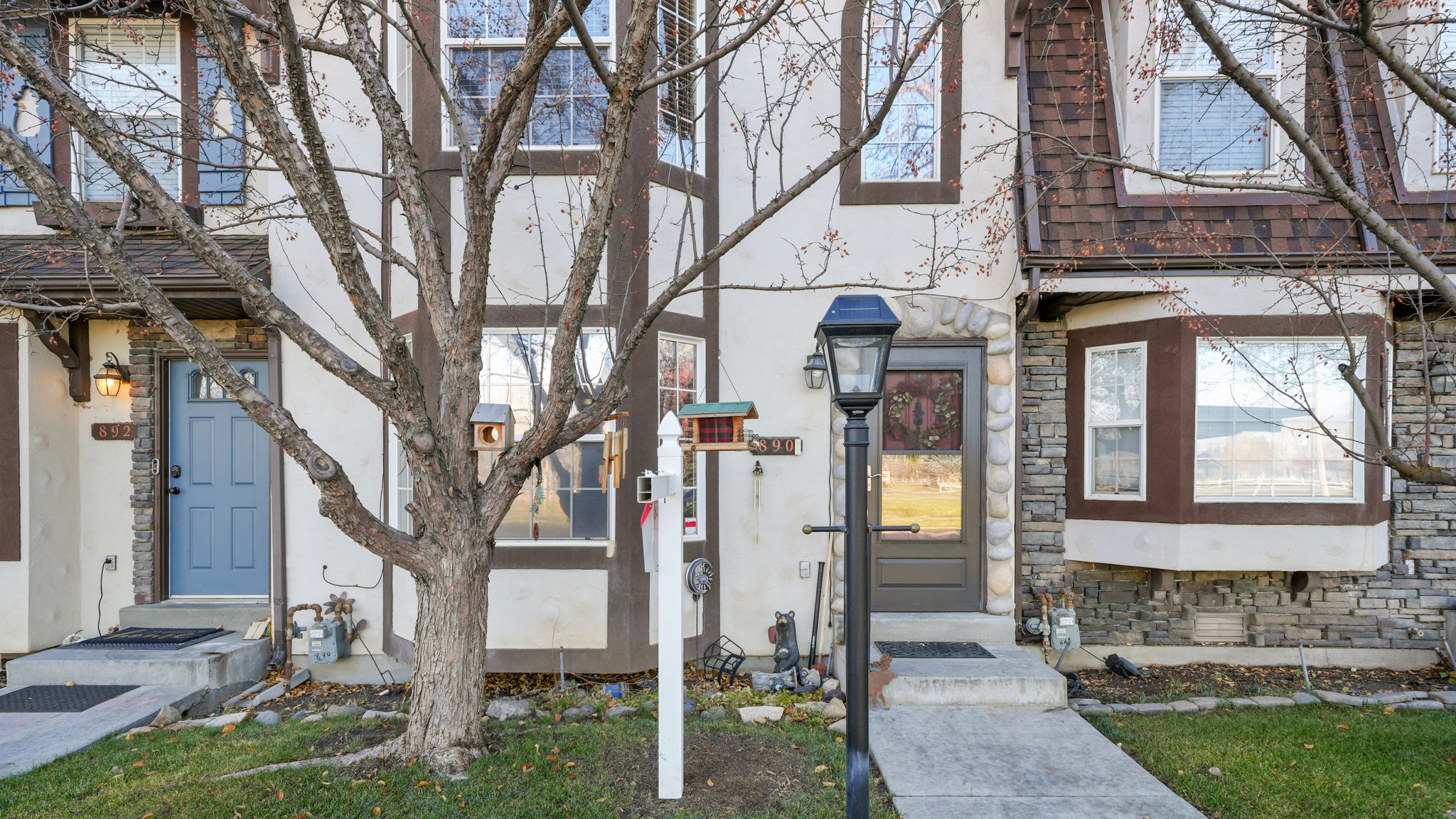 Property entrance featuring stone siding and stucco siding