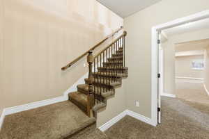 Stairway featuring carpet flooring and baseboards