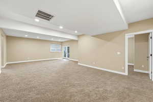 Basement with light colored carpet and recessed lighting