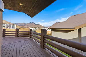 Deck with a mountain view and a residential view