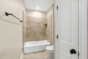 Bathroom featuring shower / washtub combination and tile patterned floors