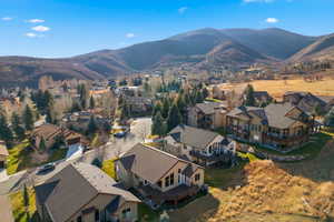 Aerial view of property's location featuring mountains and nearby suburban area