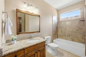 Full bathroom featuring vanity, shower / bathtub combination, and light tile patterned flooring