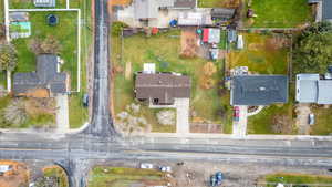 Aerial view of property and surrounding area featuring nearby suburban area