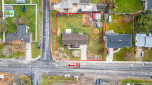 Aerial perspective of suburban area featuring property boundaries highlighted