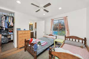 Bedroom featuring recessed lighting, wood finished floors, a ceiling fan, and a closet