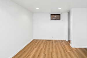 Empty room featuring light wood finished floors and recessed lighting