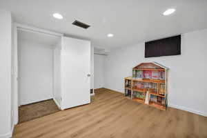 Recreation room featuring light wood finished floors and recessed lighting