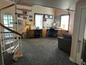 Office space featuring dark colored carpet