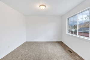 Unfurnished room with carpet and baseboards