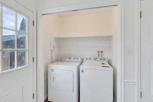 Washroom featuring washing machine and clothes dryer