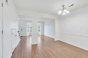 Foyer entrance with a chandelier and light wood-type flooring