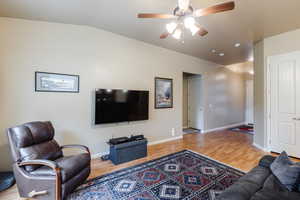 Living area with light wood-style flooring and ceiling fan