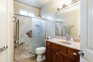 Full bathroom with vanity and a marble finish shower