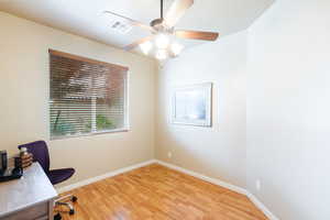 Unfurnished office featuring light wood-type flooring and a ceiling fan