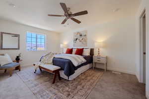 Bedroom with ceiling fan and carpet floors