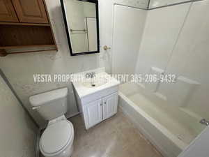 Full bathroom with tile walls, vanity, and bathtub / shower combination