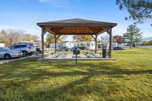 View of green lawn featuring a patio area and a residential view