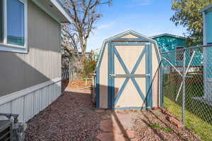 View of shed featuring a fenced backyard