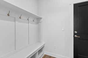Mudroom featuring baseboards and wood finished floors